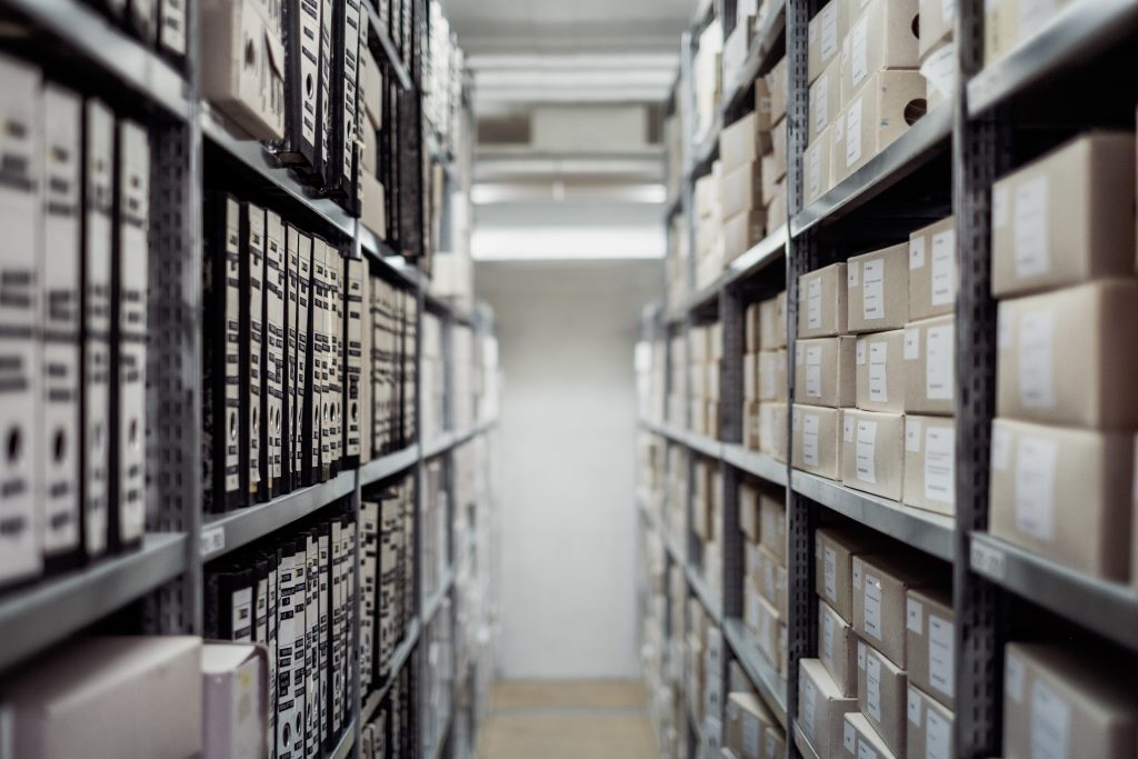 rows of archival boxes in a white room