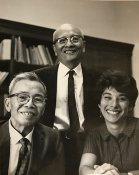 two men and one woman in an office